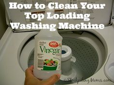 a person is holding a bottle of vinegar in front of a washing machine with instructions on how to clean your top loading machine