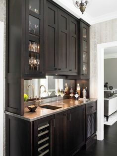 a kitchen with dark wood cabinets and white walls