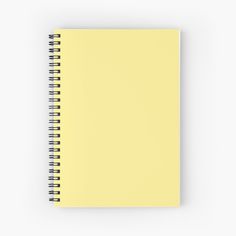 a yellow spiral notebook on a white background