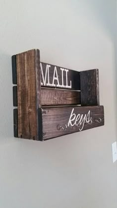 a wooden sign that says mail and keys hanging on the wall