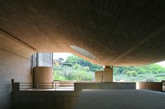 the inside of a building with concrete walls and stairs leading up to an open area