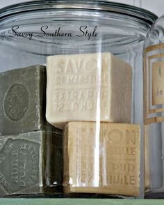 soaps are stacked on top of each other in a glass jar with labels that read savoy southern style