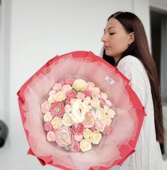 a woman holding a large bouquet of flowers