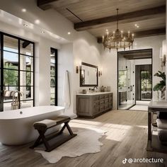 a large bathroom with a claw foot tub and chandelier