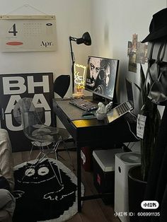 a small room with a desk, chair and pictures on the wall above it in black and white