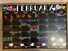 a chalkboard calendar with hearts on it