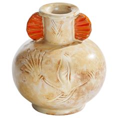 a white vase with an orange decoration on the top and bottom, sitting in front of a white background