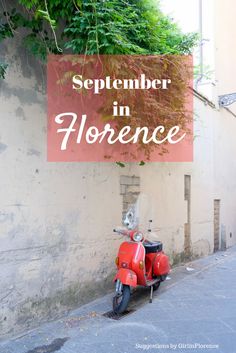 a red scooter parked in front of a sign that reads, september in horence