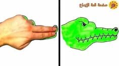 an image of a hand that is holding a green alligator's head in arabic