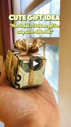 a hand holding a small gift box in front of a window with the words cute gift idea on it