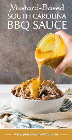 mustard - based bbq sauce being drizzled over pulled pork in a white bowl