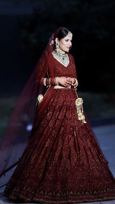 a woman in a red wedding gown and veil