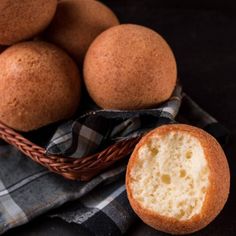 a basket filled with muffins sitting on top of a table next to a napkin