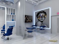 a white room with blue chairs and artwork on the wall, along with a woman's face