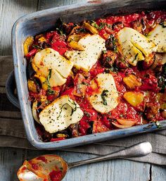 a casserole dish with eggplant, tomato sauce and cheese on top