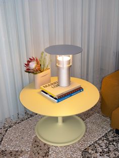 a table with a lamp and books on it