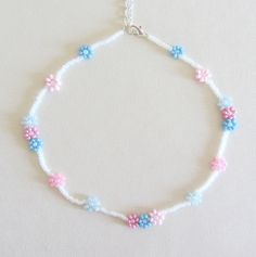 a white bracelet with blue and pink beads