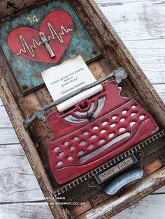 an altered photograph of a red typewriter in a box