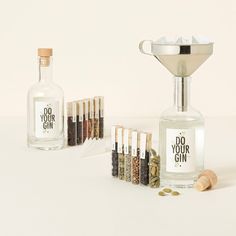 an assortment of spices and bottles on a white surface with the words do your gin written in black