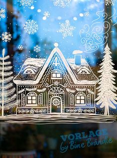 the window is decorated with snowflakes and christmas trees in front of a house