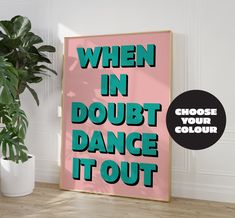 a poster with the words when in doubt, dance it out next to a potted plant