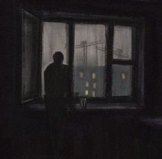 a man standing in front of a window at night