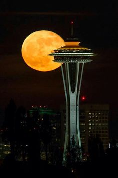 the supermoon rises above the space needle in seattle