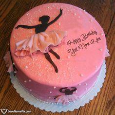 a pink birthday cake with a ballerina on it