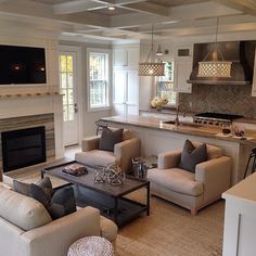 a living room filled with furniture and a flat screen tv mounted on the wall above a fireplace