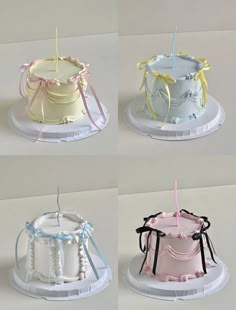 four different types of cakes with candles in them and ribbons tied around the top one