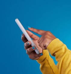 a woman holding a white tablet computer in her right hand and pointing it at the screen