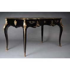 an antique black and gold console table with two drawers on one side, in the shape of a desk