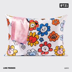 a pillow with flowers on it and a pink ribbon hanging off the side of it