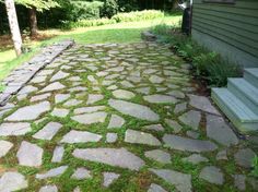 a stone path in front of a house