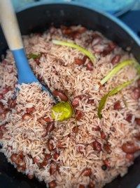 rice and beans are being cooked in a skillet