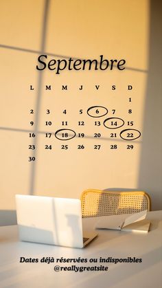 a laptop computer sitting on top of a desk next to a wall with the date