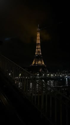 the eiffel tower is lit up at night