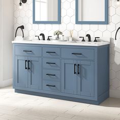 a bathroom vanity with two sinks and mirrors