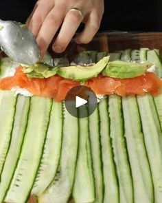 someone cutting up some food on top of a table