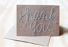 a thank you card with the words thank you written on it in light blue thread