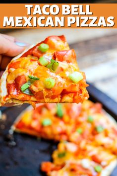 a hand holding up a piece of taco bell mexican pizza