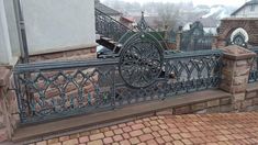 a wrought iron fence on top of a brick building