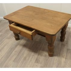 an old wooden table with two drawers on the bottom and one drawer at the top