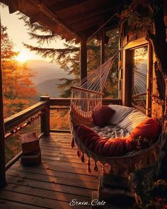 a hammock hanging from the side of a wooden porch