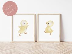 two watercolor paintings of yellow ducks on white wall with chevron wood flooring