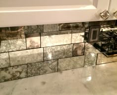 a kitchen counter with an oven and tile backsplash in the middle, next to a stove