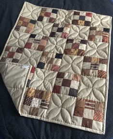 a close up of a quilt on a bed