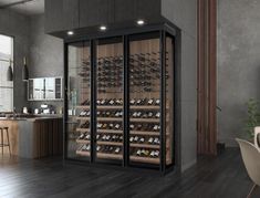 a large wine cellar in the middle of a room with wooden floors and gray walls