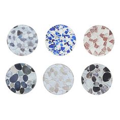 four different colored stones are arranged in the shape of circles