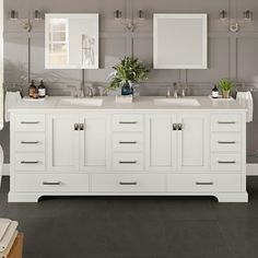 a bathroom with double sinks and mirrors on the wall above them is shown in white